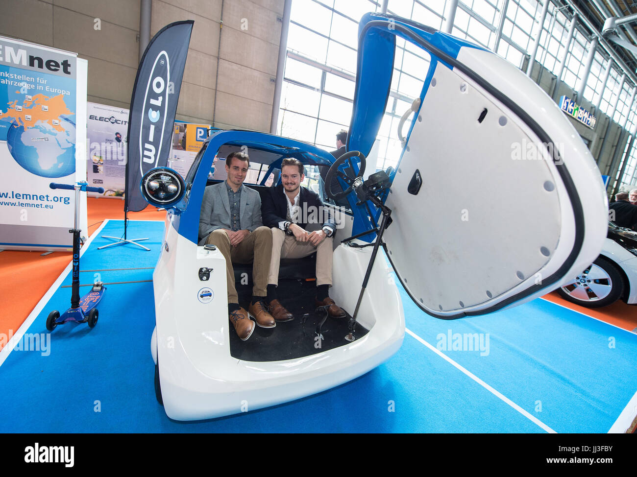 Hanover, Germany. 26th Apr, 2017. Pascal Studerus (L), project manager at Microlino, and Oliver Ouboter, a marketing manager at Micro, in a Micro Microlino e-car at the Hanover Trade Fair 2017 in Hanover, Germany, 26 April 2017. The car is modelled on a 1950s BMW Isetta. 6,500 exhibitors participated in the 2017 Hanover Trade Fair. The partner nation was Poland. Photo: Silas Stein/dpa/Alamy Live News Stock Photo