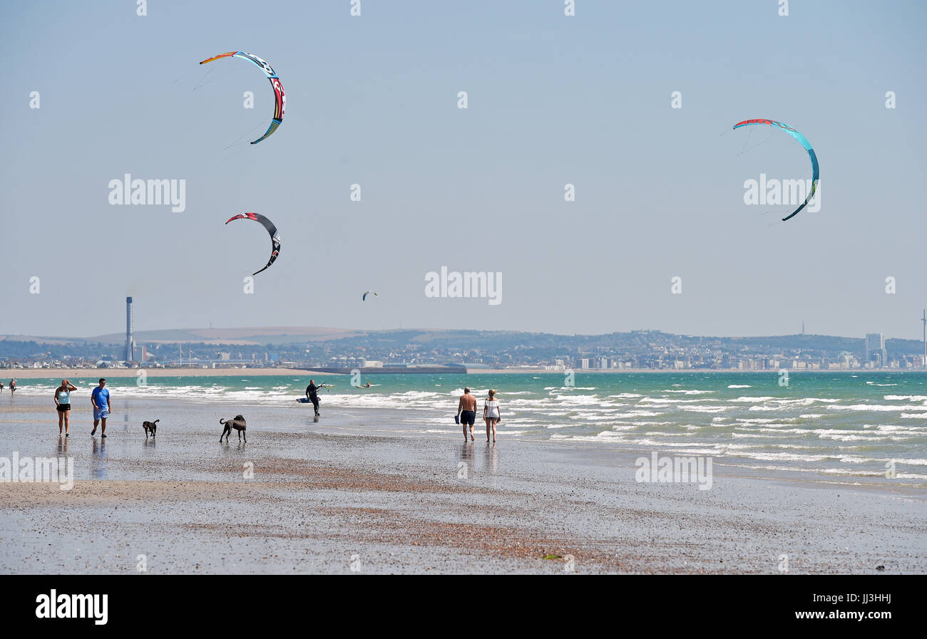 Lancing Sussex, UK. 18th July, 2017. Perfect conditions for kite surfing and sunbathing on a beautiful hot sunny day at Lancing beach near Worthing but thunder storms and rain are forecast for the next few days in the UK Credit: Simon Dack/Alamy Live News Stock Photo