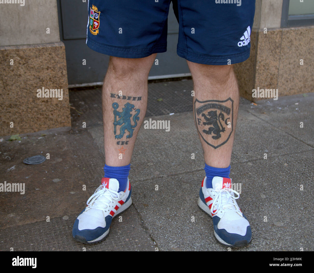 Glasgow, Scotland, UK. 18th July. Summer weather returns and people enjoy the summer in the city's Botanics and George Square as Scotland catches some of the scorching UK weather  Chelsea and Dundee united tattooed  British lions shorts  legs oot Credit Gerard Ferry/Alamy news Stock Photo