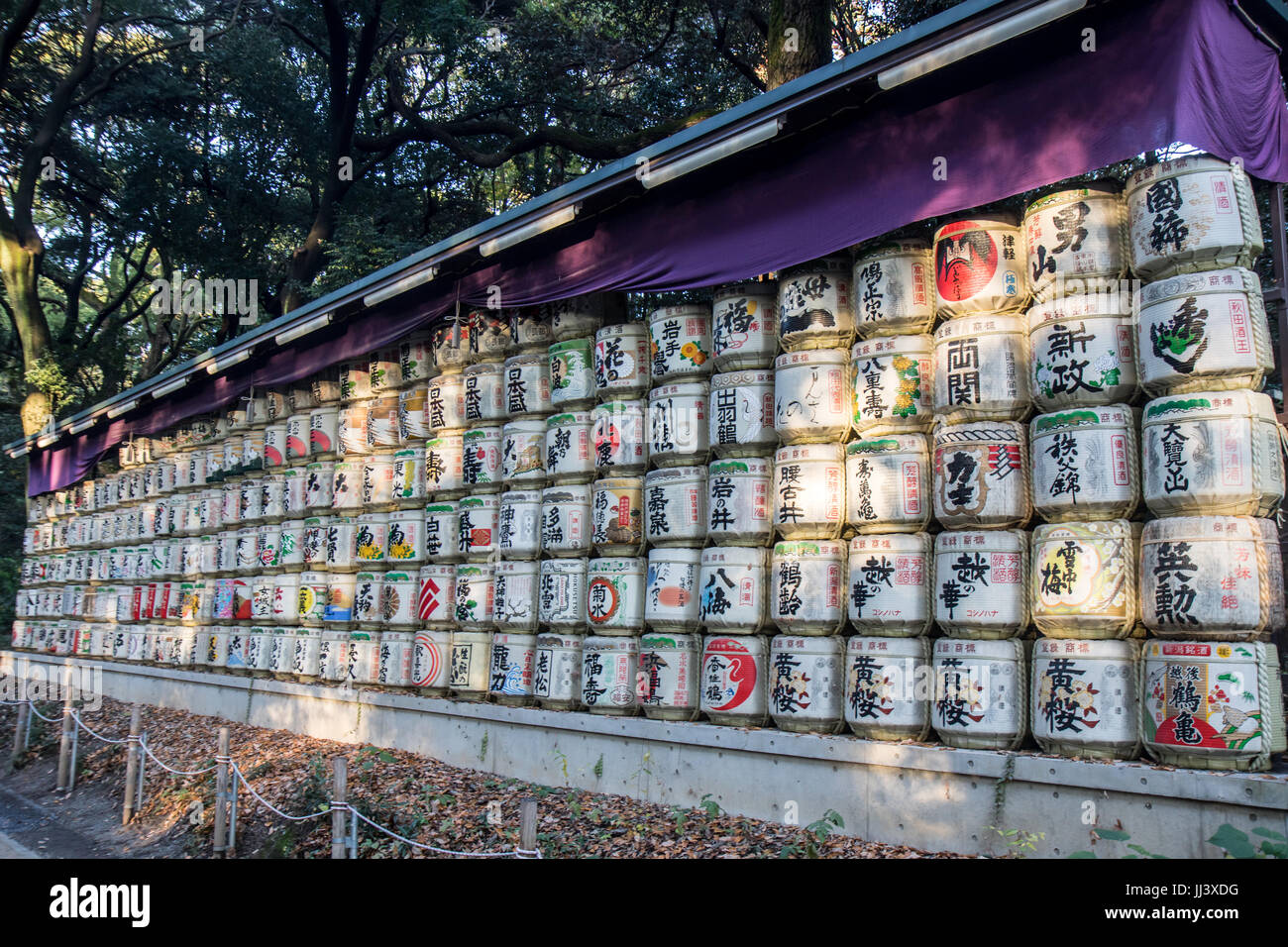 TOKYO, JAPAN - NOVEMBER 22, 2016, A collection of Japanese sake barrels. Traditional painted barrels in lines. Stock Photo