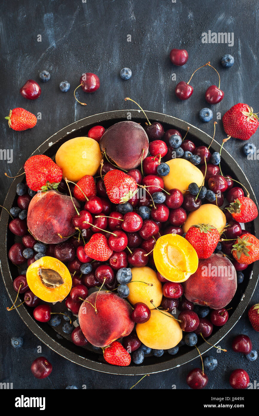 Fresh ripe summer berries and fruits (peaches, apricots, cherries and