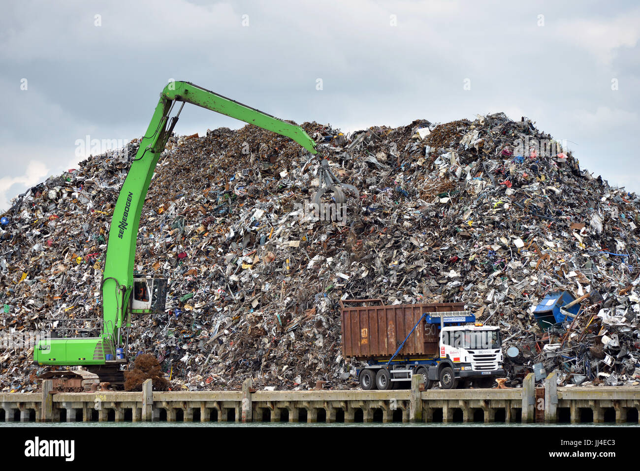 Scrap metal pile waiting for recycling with crane, Newhaven port, East Sussex Stock Photo