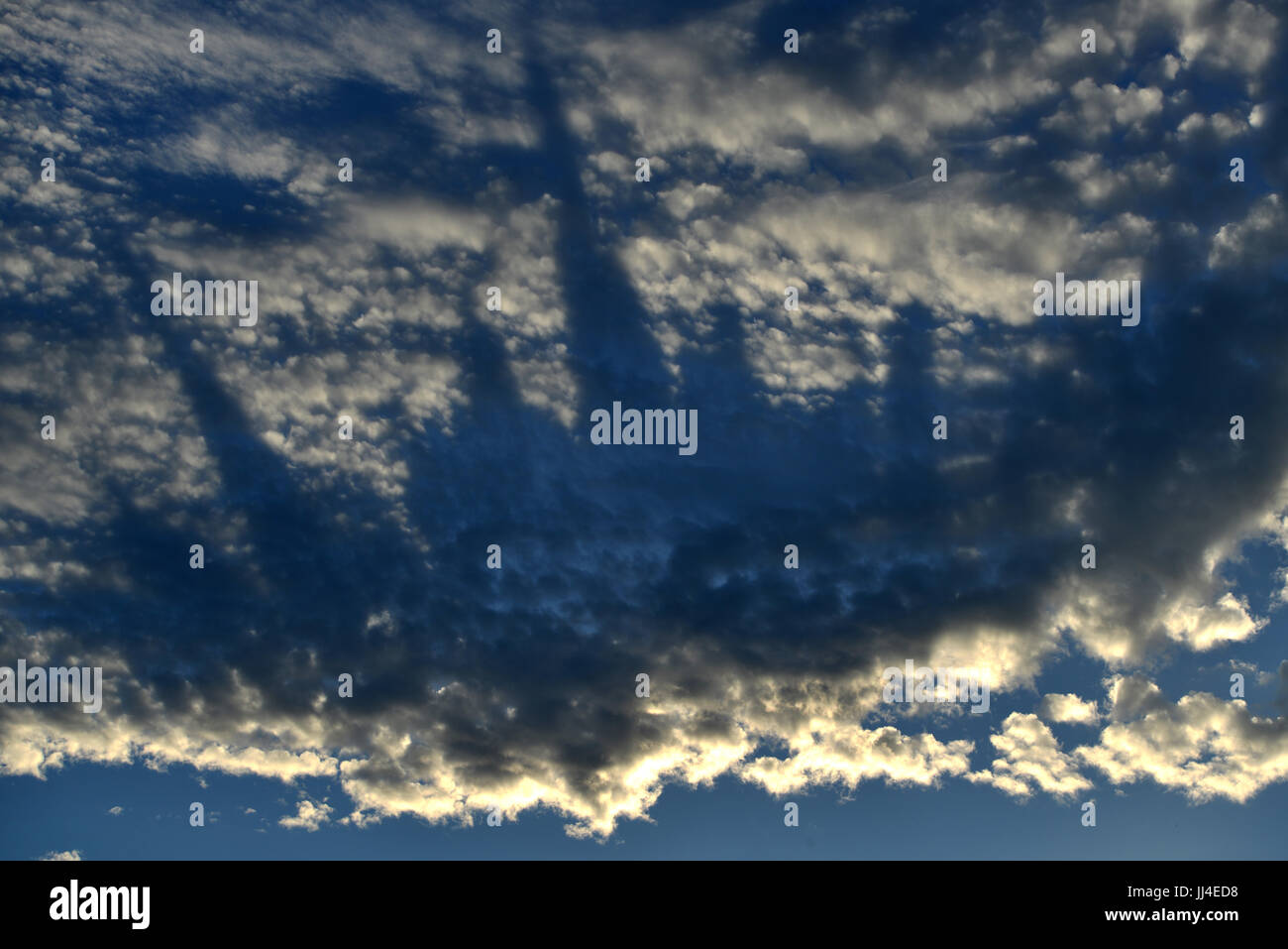 Strange shadows reminiscent of a city-scape in evening clouds Stock Photo