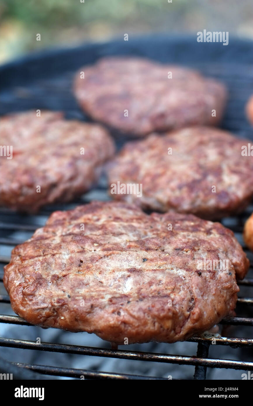 Sausages and burgers cooking on a BBQ Stock Photo Alamy