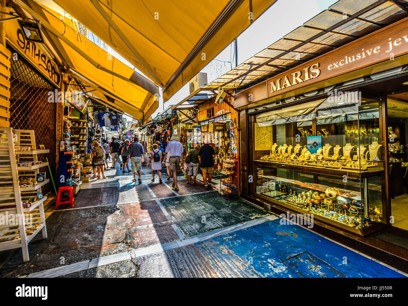 Tourists shopping and sightseeing in an outdoor market in the Plaka district of Athens Greece on a warm summer day Stock Photo