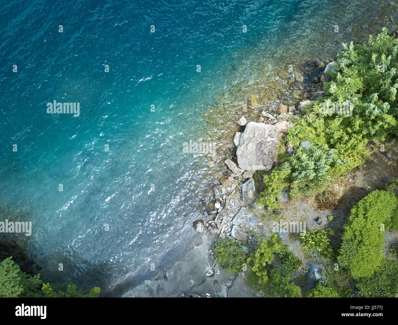 Above view on lagoon shore. Blue water beach with rocks Stock Photo