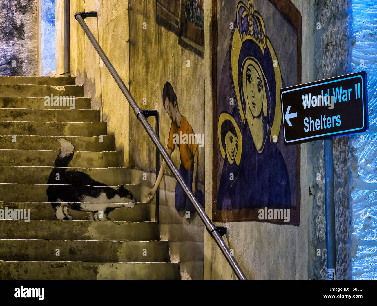 Information sign pointing to air raid shelters - Mellieha, Malta. Stock Photo