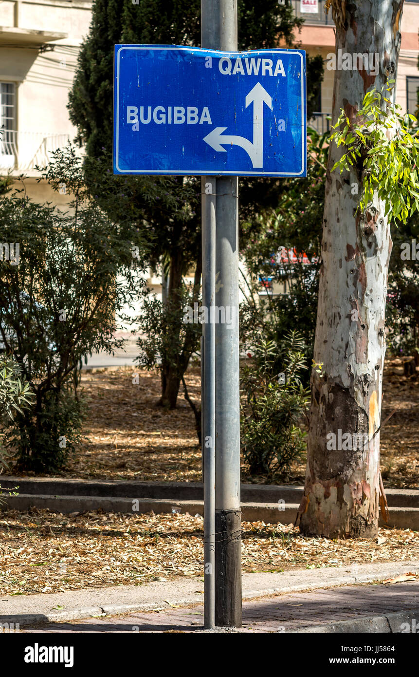 Malta, Bugibba: Blue road sign showing the way to some popular tourist destinations. Stock Photo