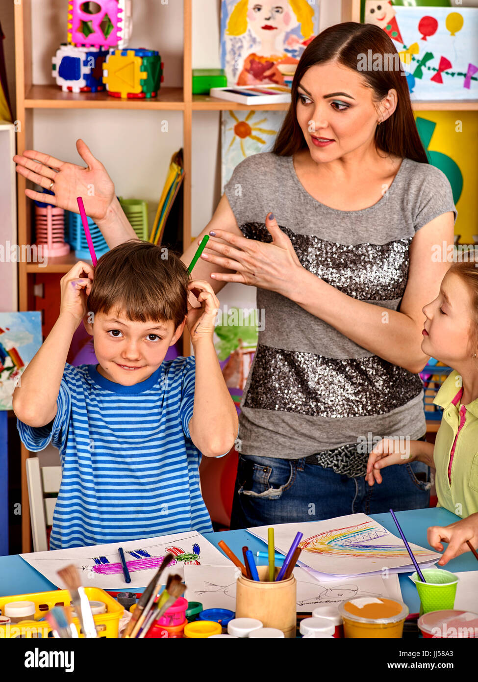 Small students girl and boy painting in art school class Stock Photo ...