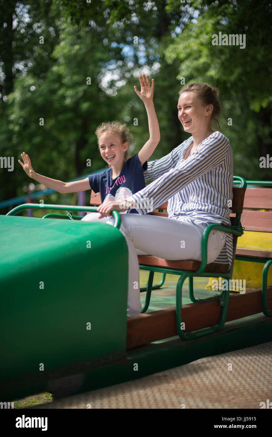Little girl and her mother having fun on roller coaster Stock Photo Alamy