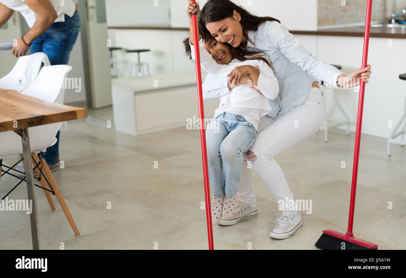 Happy mother with her child cleaning house Stock Photo