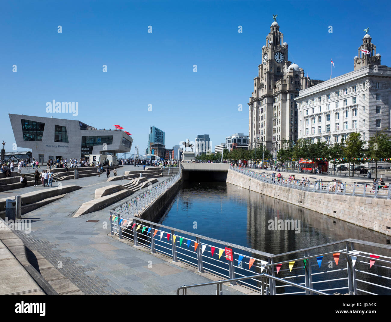 Pier Head Liverpool showing (L to R) Mersey Ferries terminal, Royal Liver Building and Cunard Building. In the centre is the Liverpool Canal Link. Stock Photo
