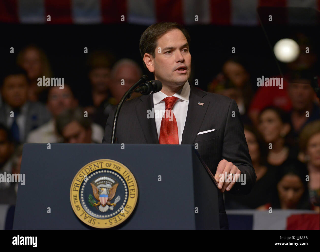 U.S. President Donald Trump delivers remarks to a crowd of people and ...