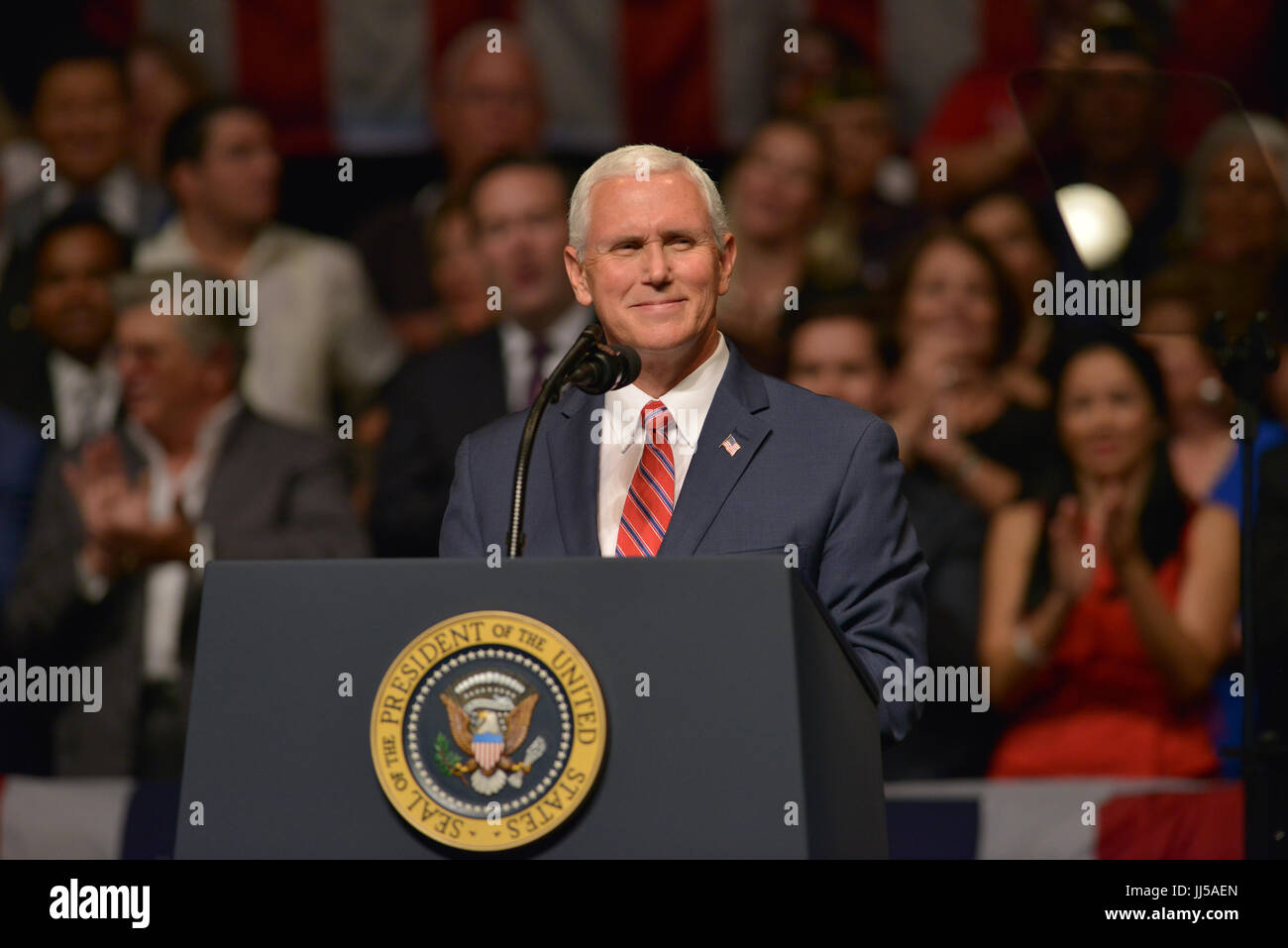 U.S. President Donald Trump delivers remarks to a crowd of people and ...