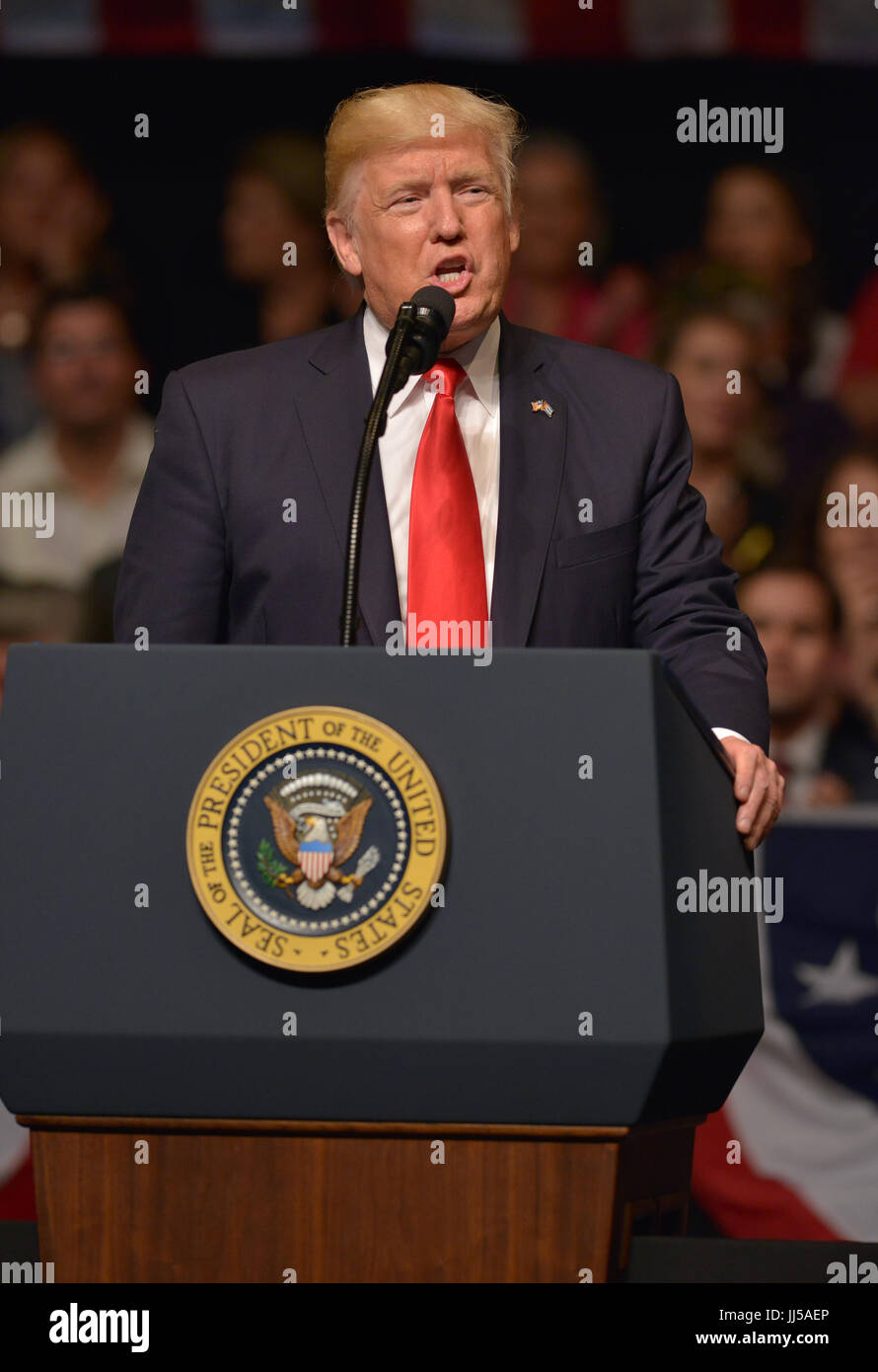 U.S. President Donald Trump delivers remarks to a crowd of people and ...
