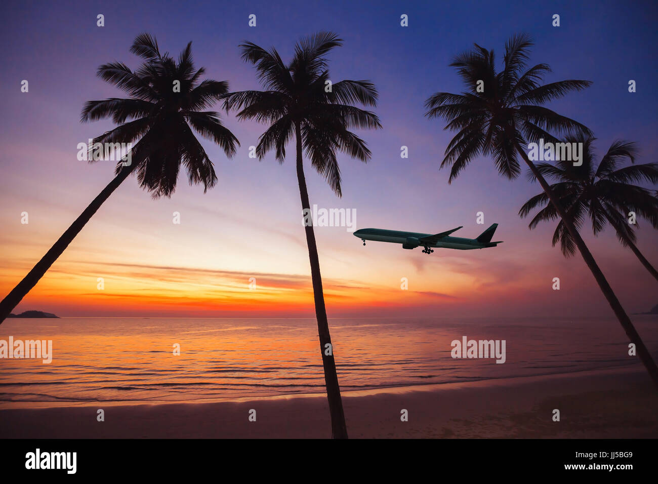 airplane taking off at sunset, holidays on tropical island concept, flight, beach travel Stock Photo