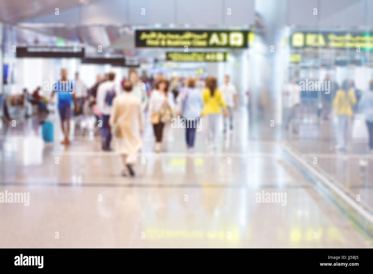 blurred airport background, people walking in modern international terminal of Doha Stock Photo