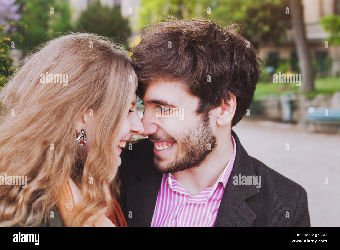 portrait of young happy couple laughing together outside, affectionate man and woman having fun Stock Photo