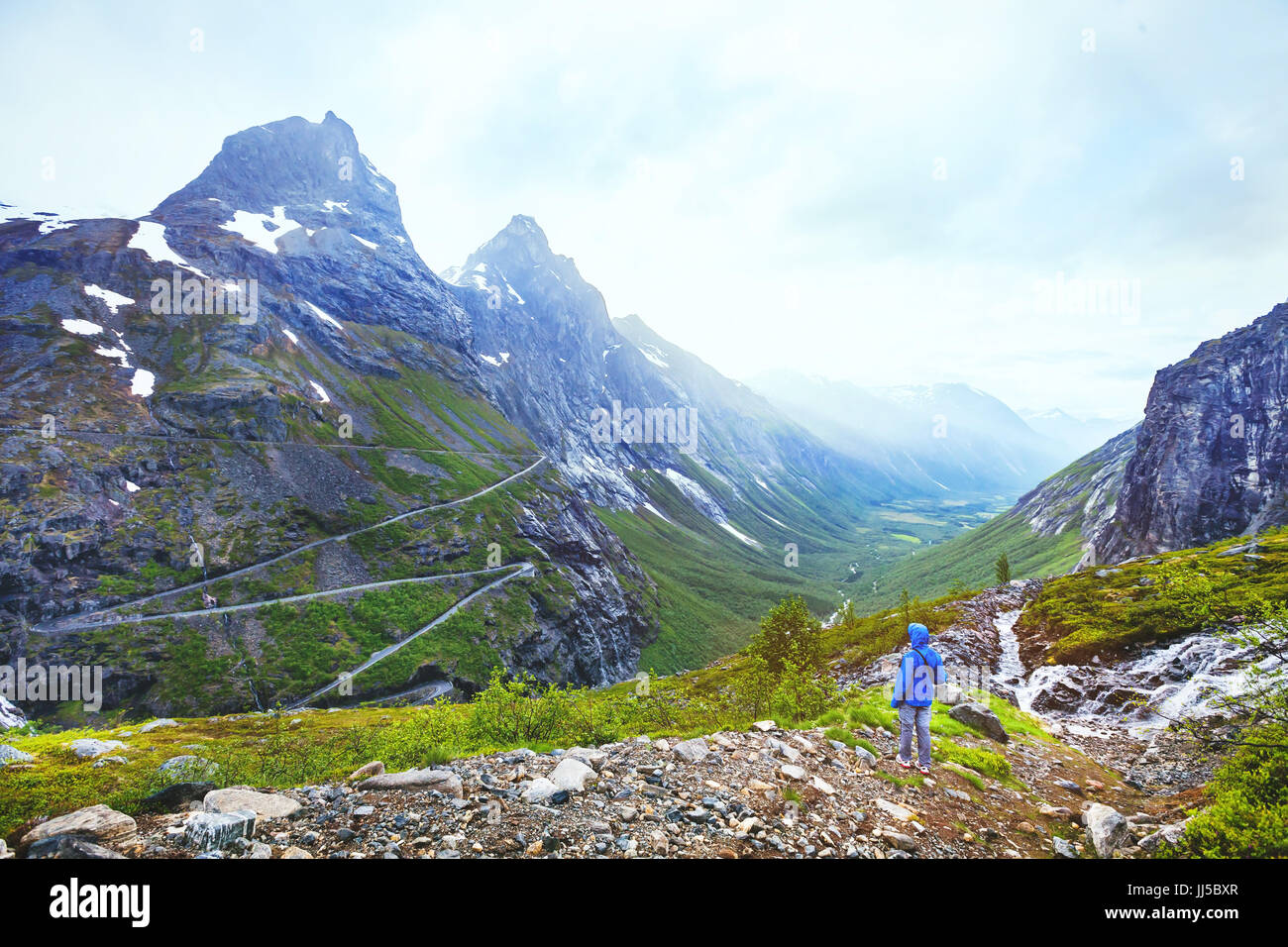Trollstigen in Norway, tourist looking at mountain road in stunning beautiful landscape Stock Photo