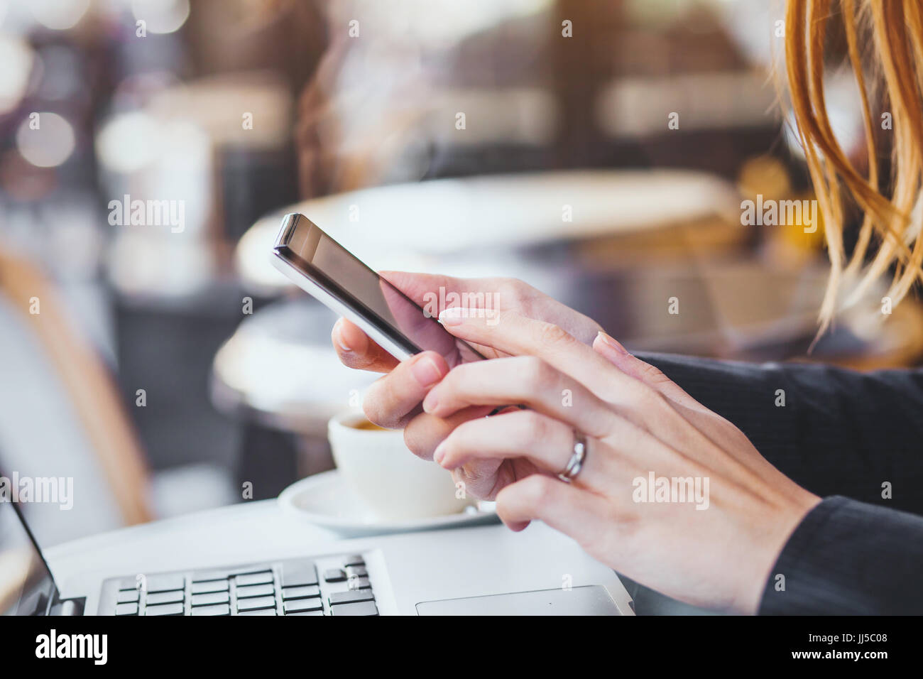 woman hands holding smartphone on city background Stock Photo - Alamy