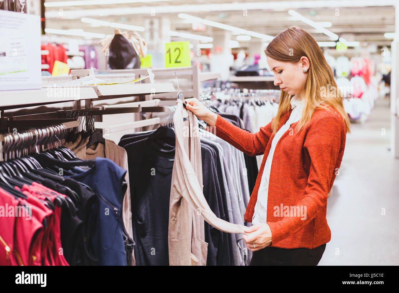 shopping, woman choosing clothes in the shop Stock Photo