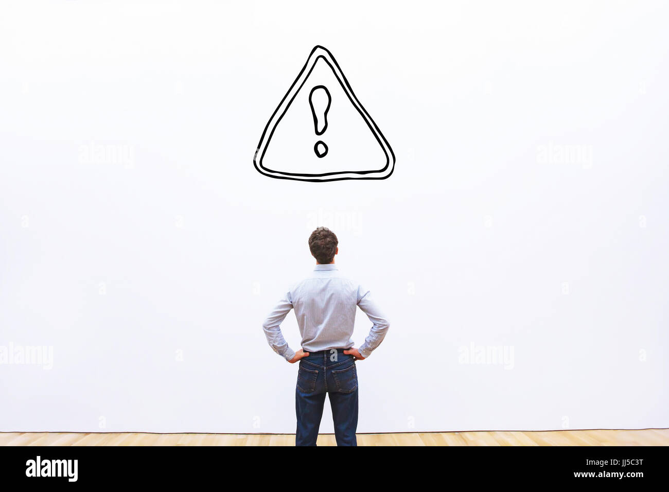 restrictions or alert concept in business, businessman looking at danger sign on white background Stock Photo