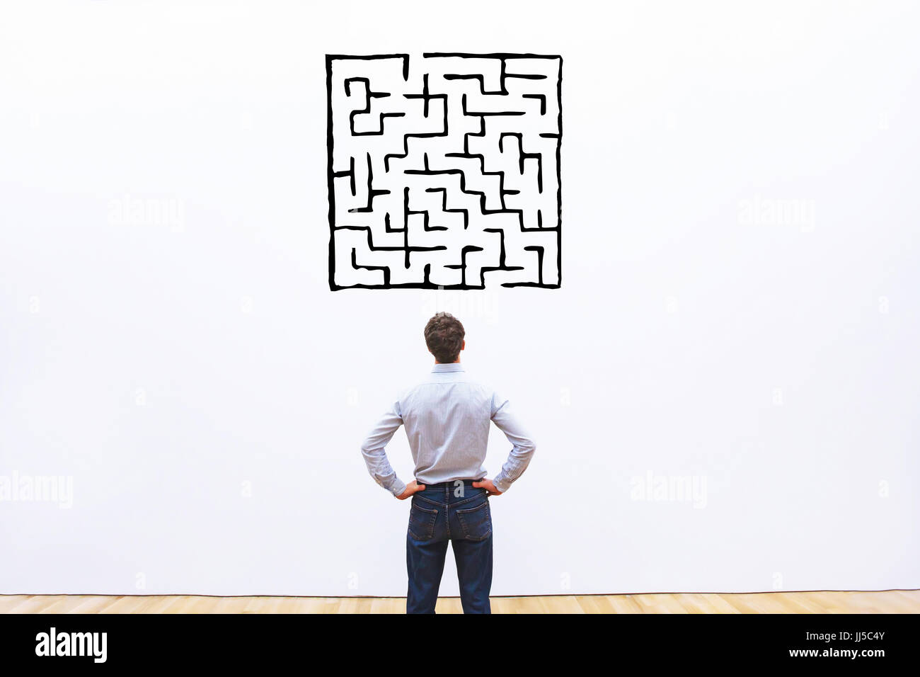 business man looking at labyrinth drawing, complicated difficult solution concept Stock Photo