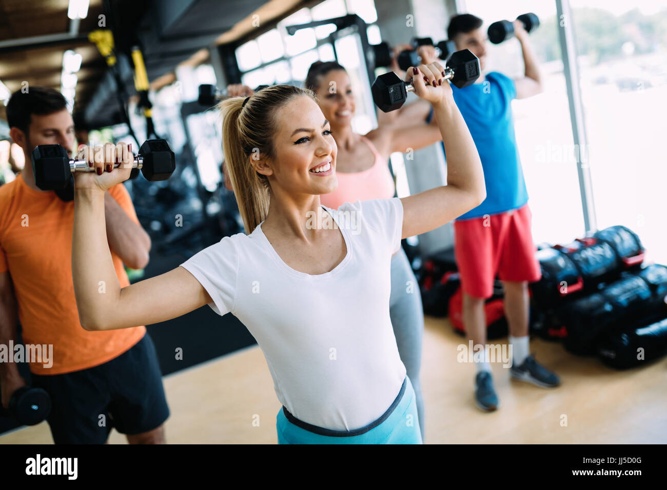 Group of people training together in gym Stock Photo