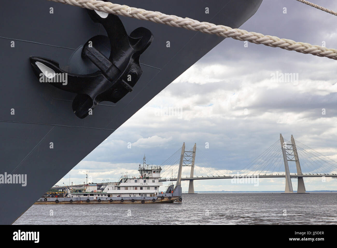 Anchor of the warship against a background of the cable-stayed bridge over the ship's fairway Stock Photo