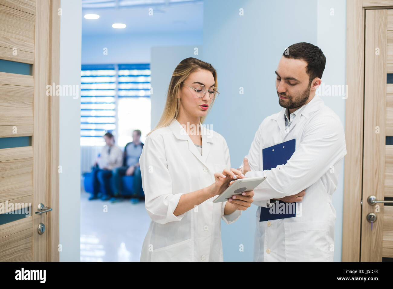 Medical Staff Having Discussion In Modern Hospital Corridor Stock Photo ...