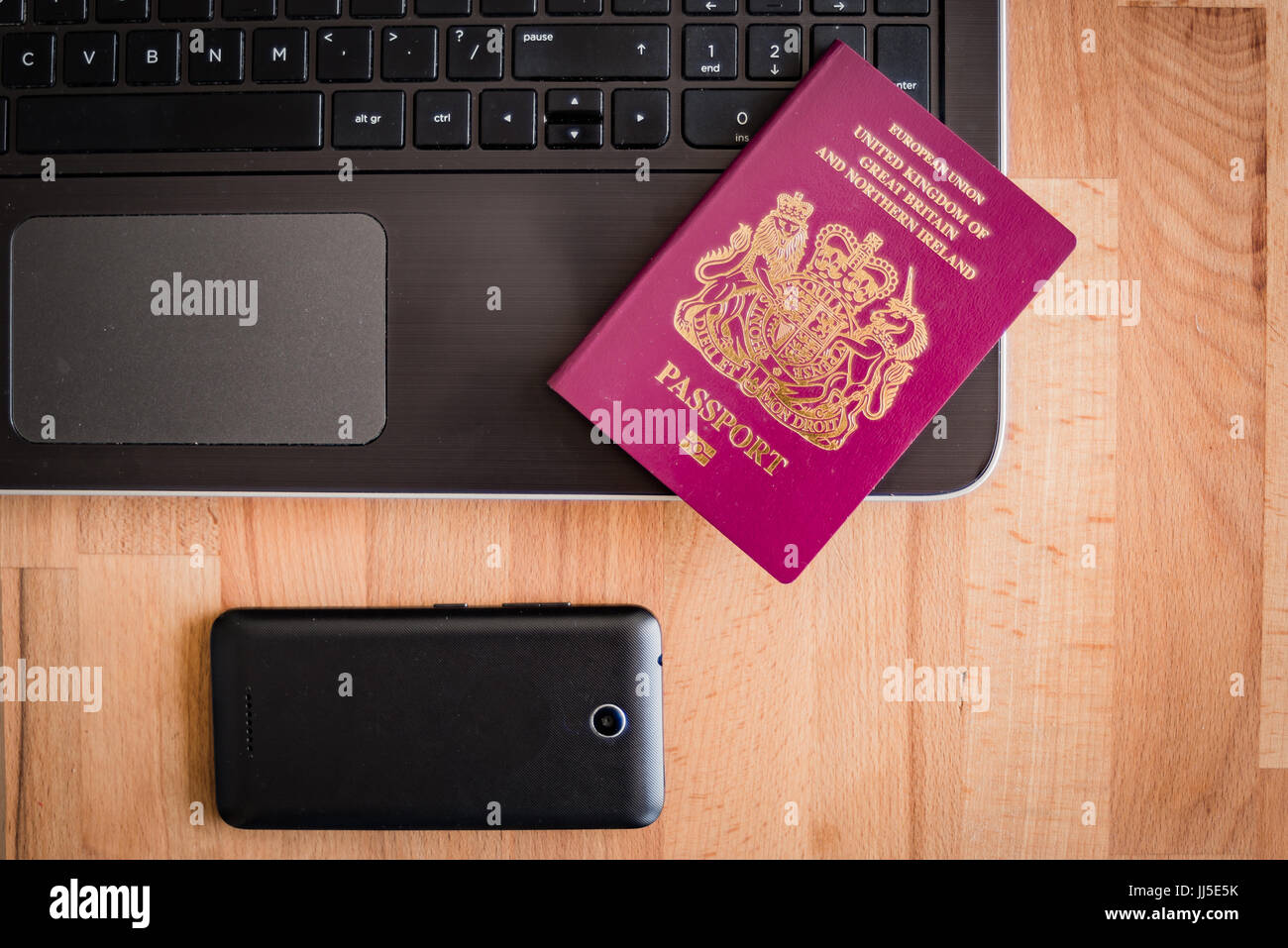 Passport, Laptop and smart phone for business travel. Stock Photo