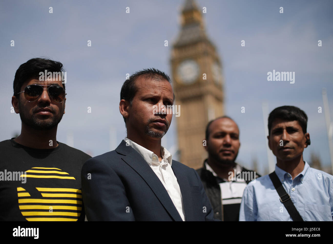 Jabed Hussain (2nd left), 32, a rider for UberEATS who had his moped stolen when two suspects also riding a moped sprayed him with liquid, during a food delivery riders demonstration in Parliament Square following moped acid attacks after five separate male victims were targeted by two moped-riding attackers in the north and east of the capital on Thursday night. Stock Photo