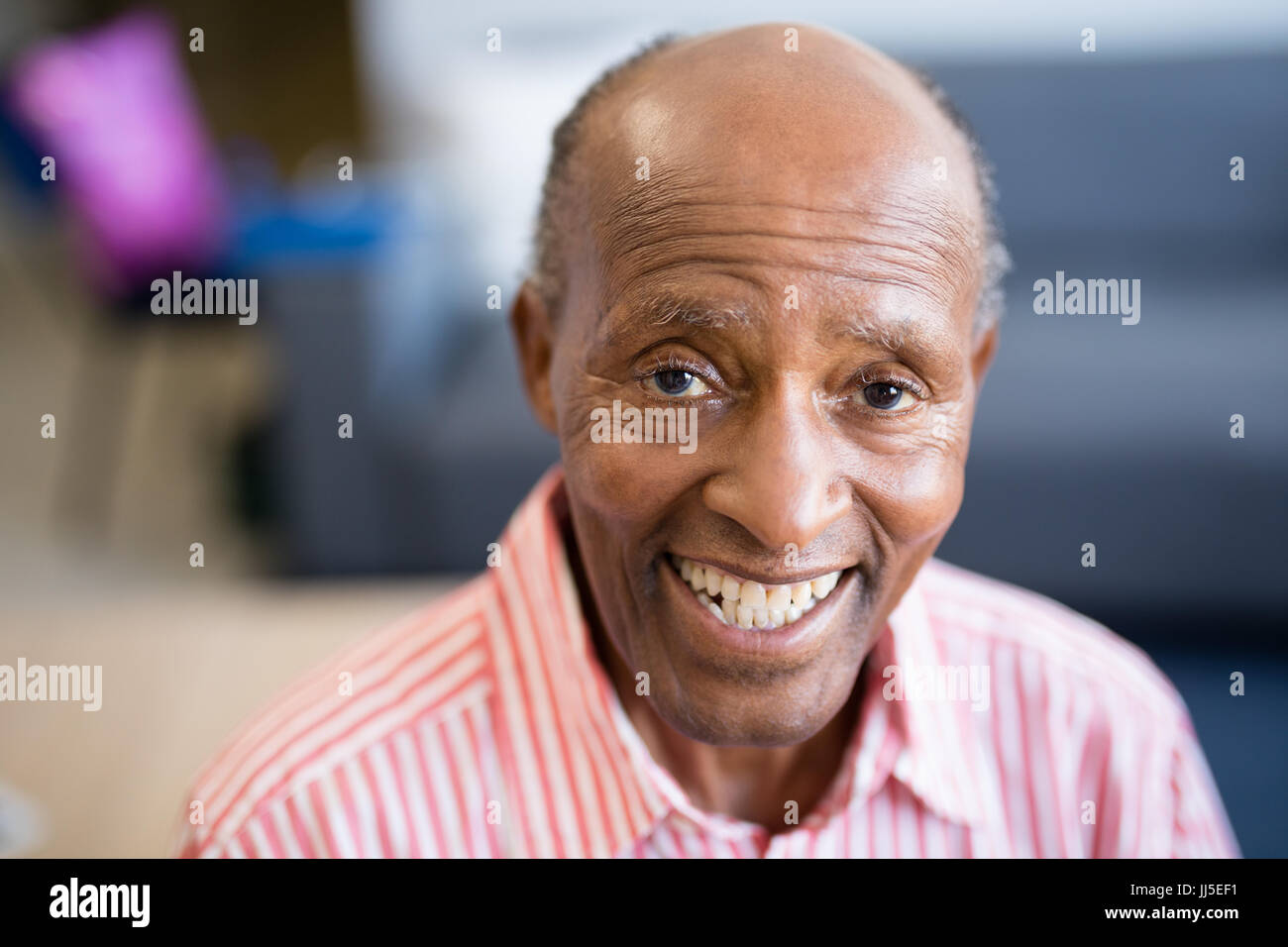 Portrait of smiling senior man with receding hairline at nursing home Stock Photo