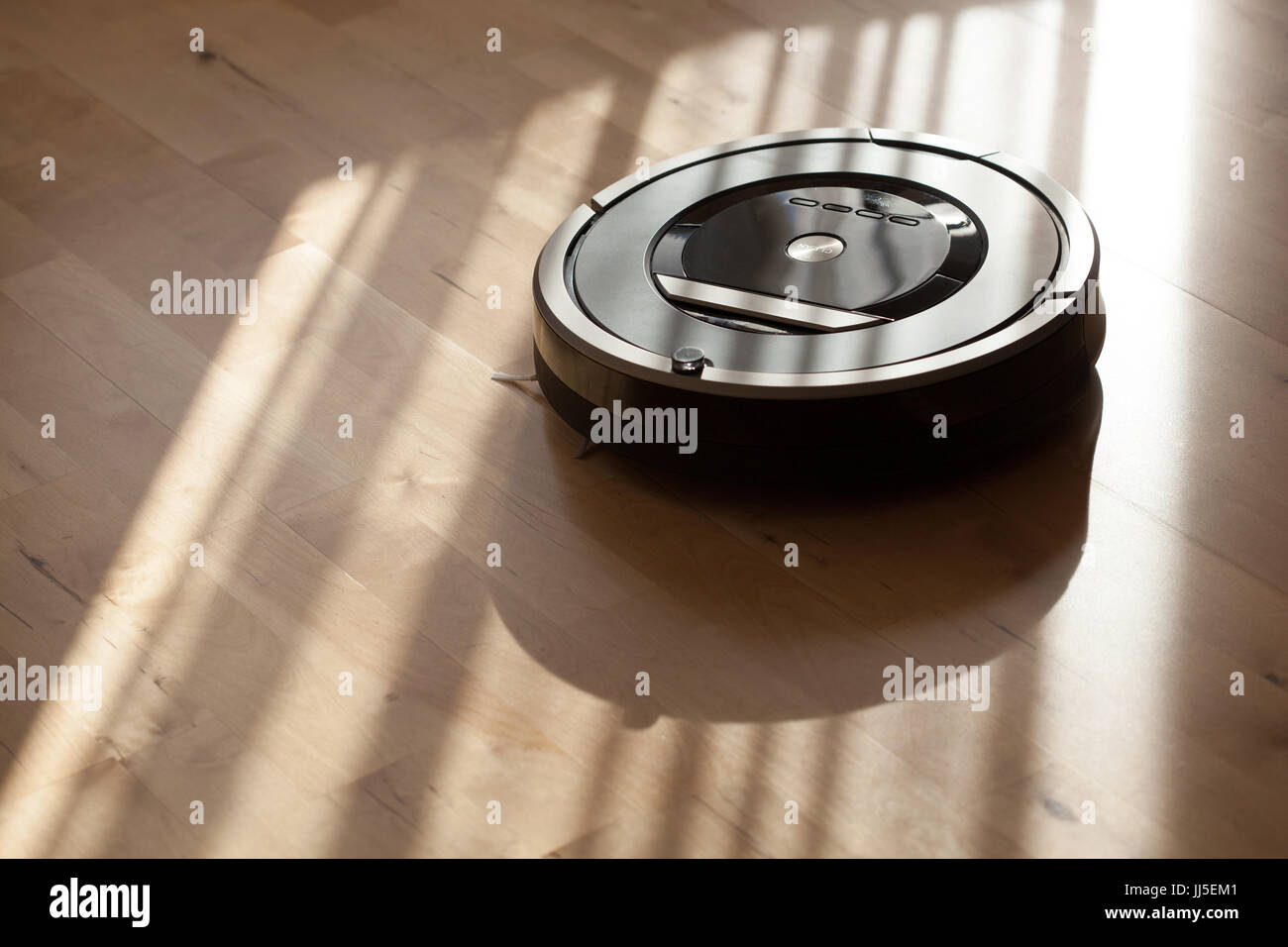robotic vacuum cleaner on laminate wood floor smart cleaning technology