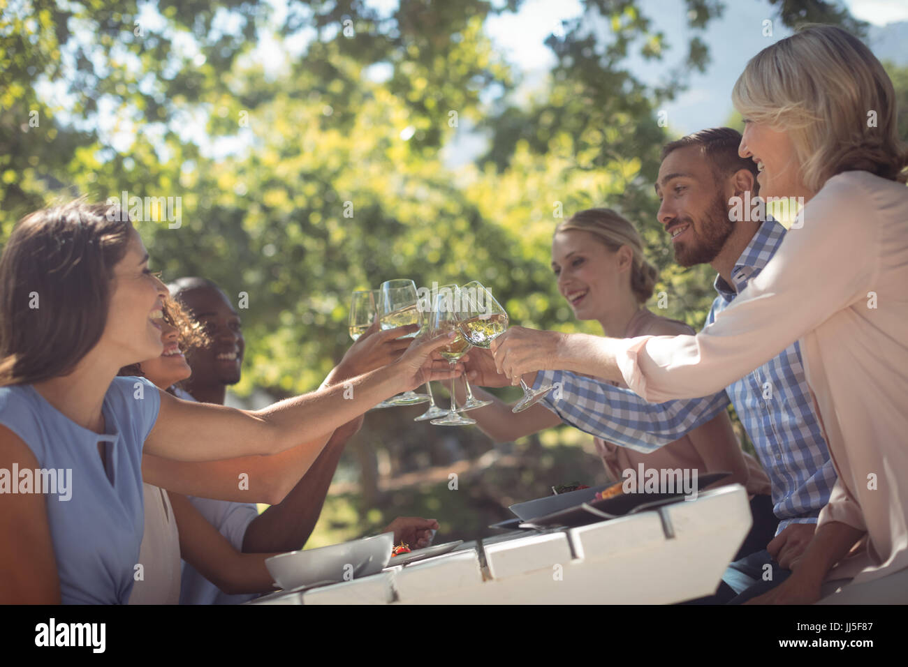 Happy friends toasting glasses of wine in a restaurant Stock Photo