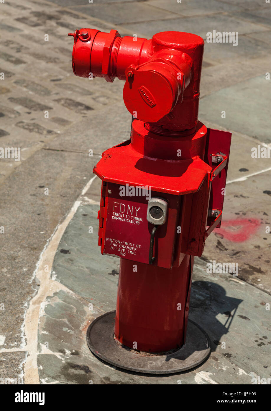 Bright red fire hydrant near in Fulton Street at South Street Sea Port in Manhattan Stock Photo