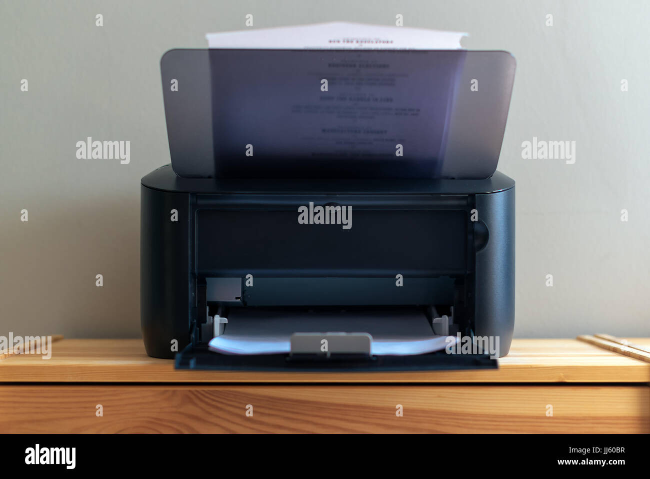 Small office printer printing documents, selective focus Stock Photo