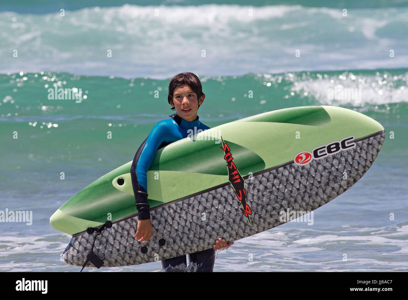 Young surfer boy and surfboard Stock Photo