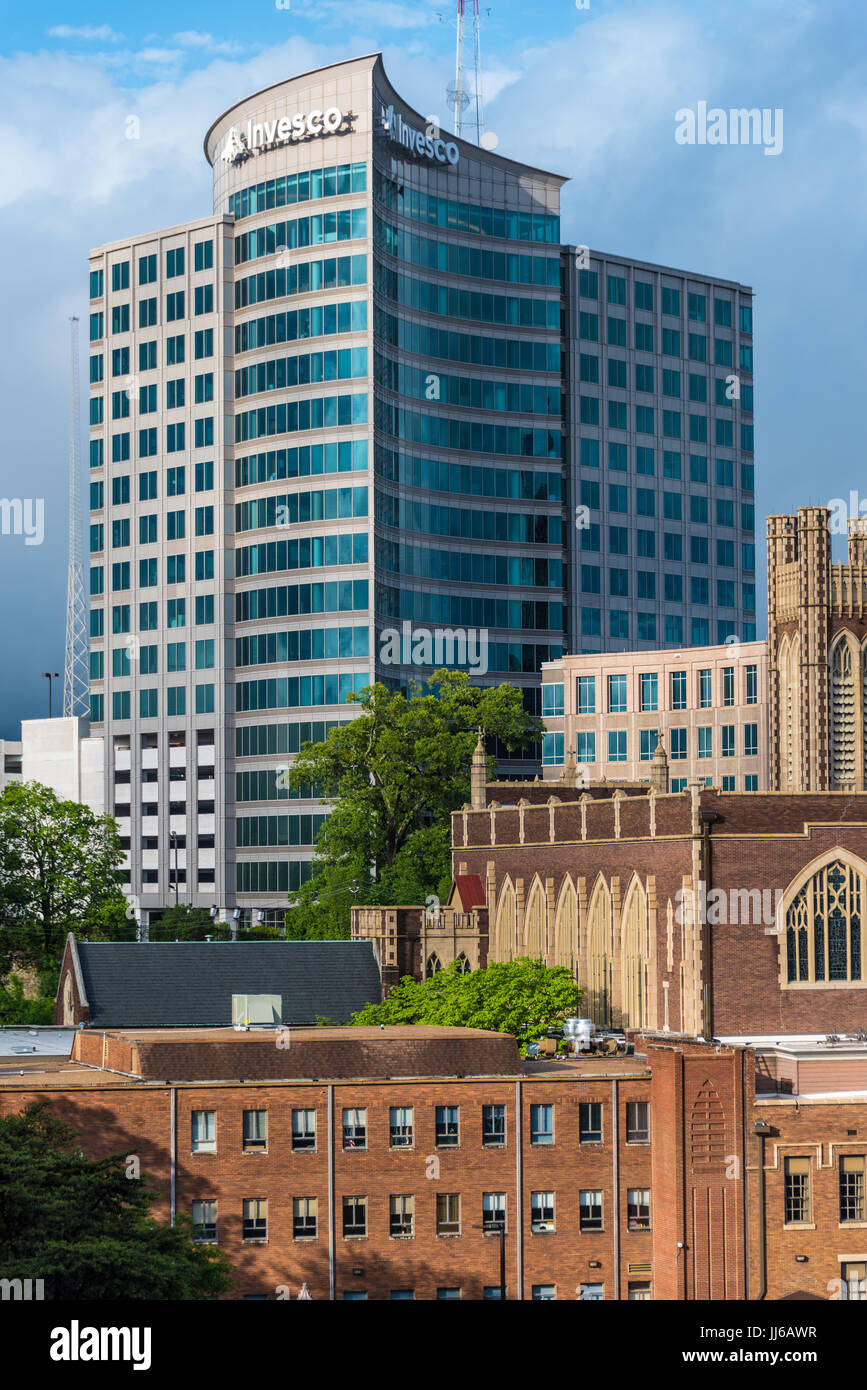 The modern glass Invesco building towers above the historic architecture of Peachtree Christian Church along Peachtree Street in Midtown Atlanta, GA. Stock Photo