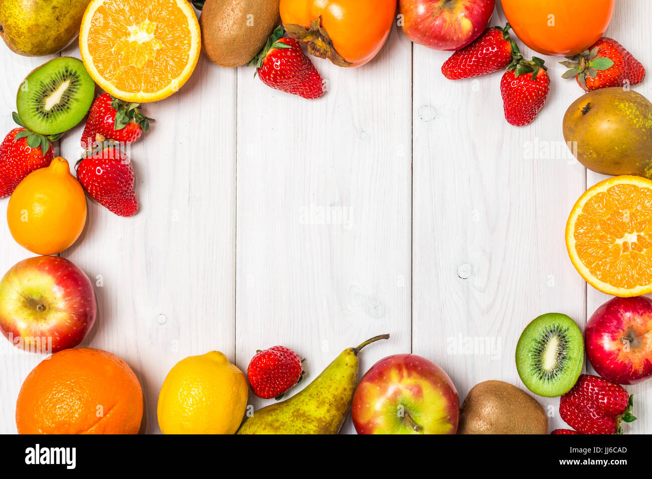 Fruit Background Frame Fruits and berries frame on white wooden background. Copy space Stock ...