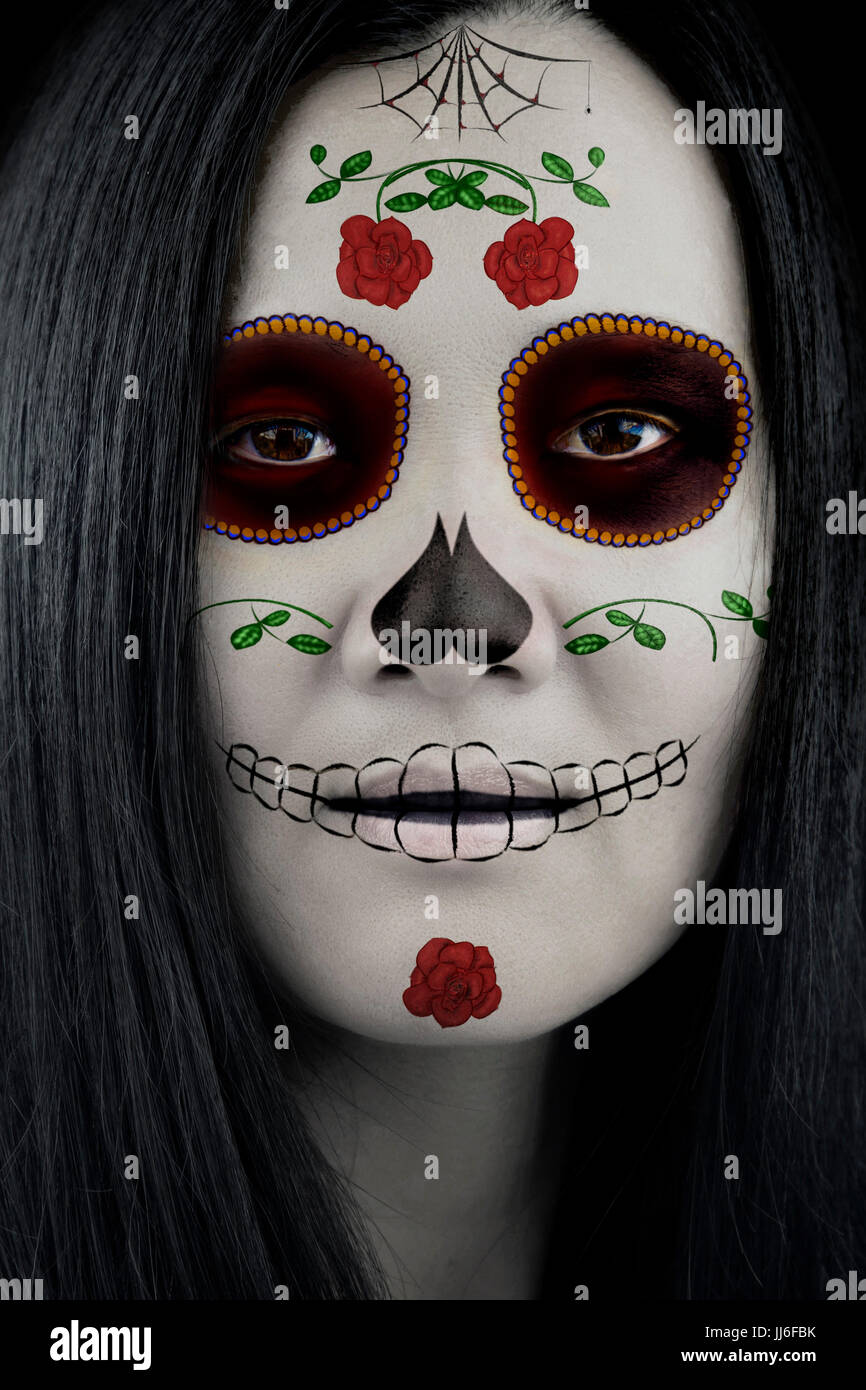 Woman in Dia de los Muertos Sugar Skull Catrina makeup. Stock Photo