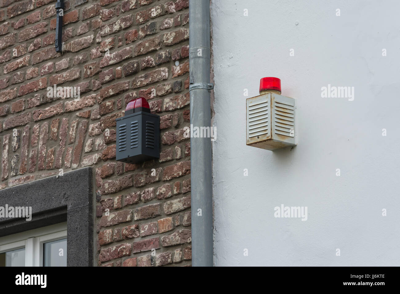 Two alarm systems with warning lights on a house wall Stock Photo - Alamy