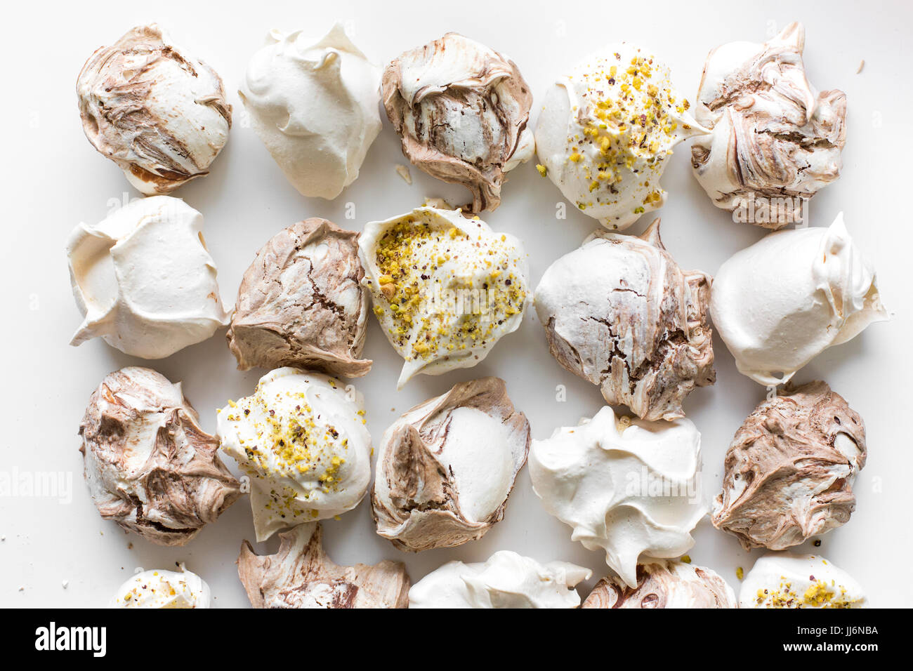 Closeup of mini meringues on white as food background. Top view