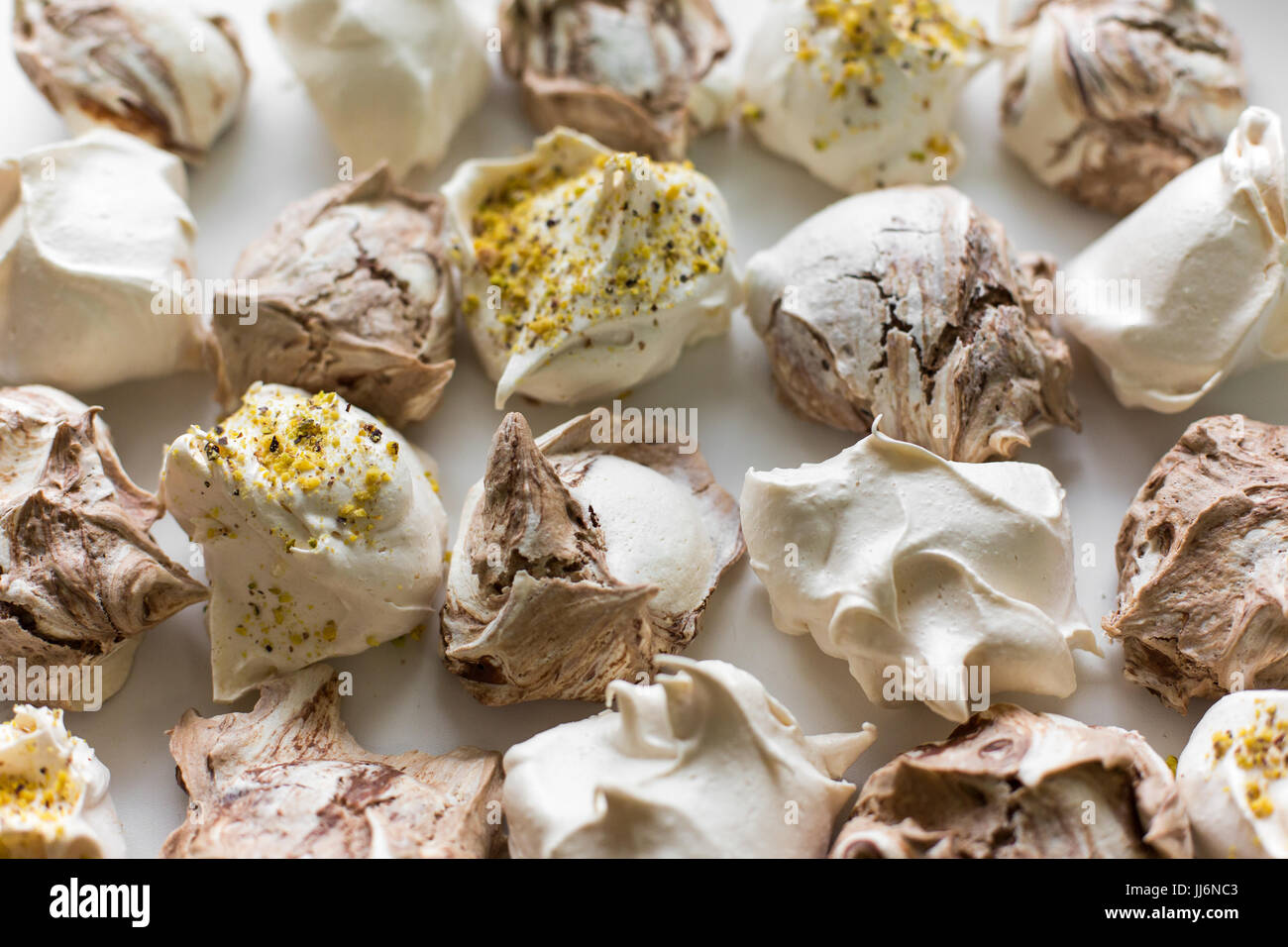Closeup of mini meringues on white as food background. Top view