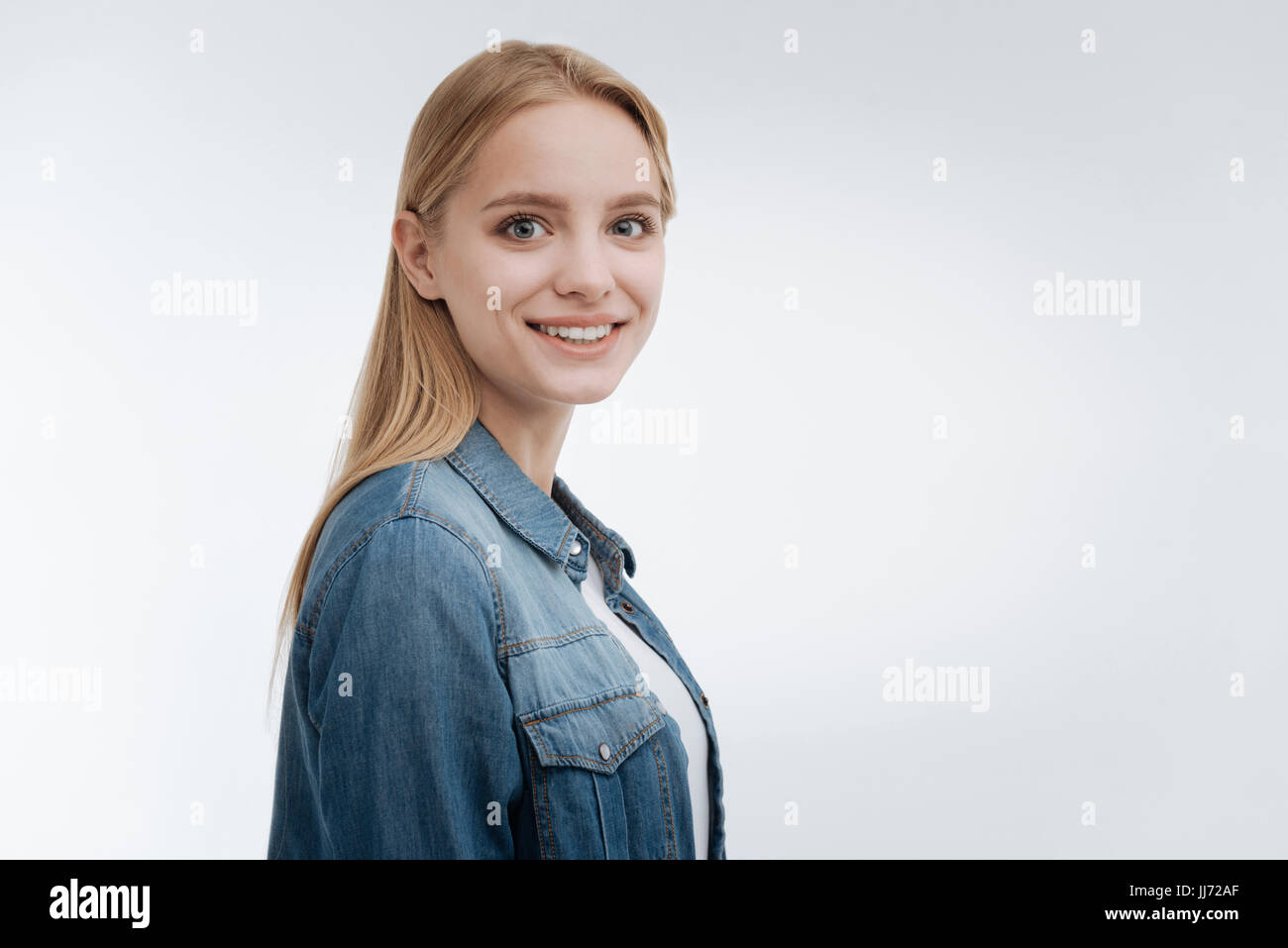 Smiling Position Pretty smiling girl standing in semi position Stock Photo - Alamy