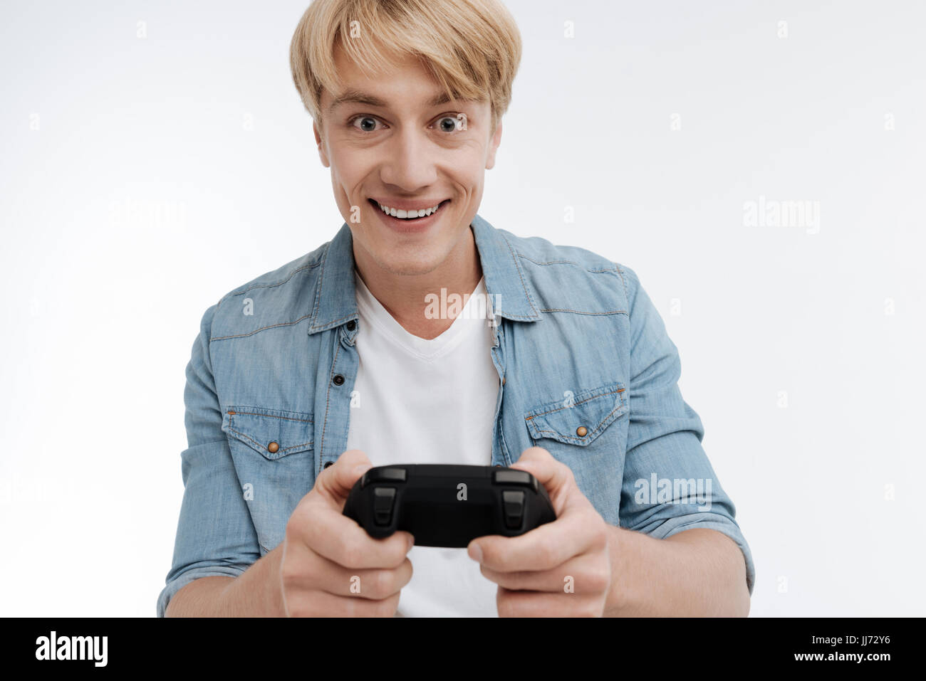 Positive delighted male person playing computer game Stock Photo