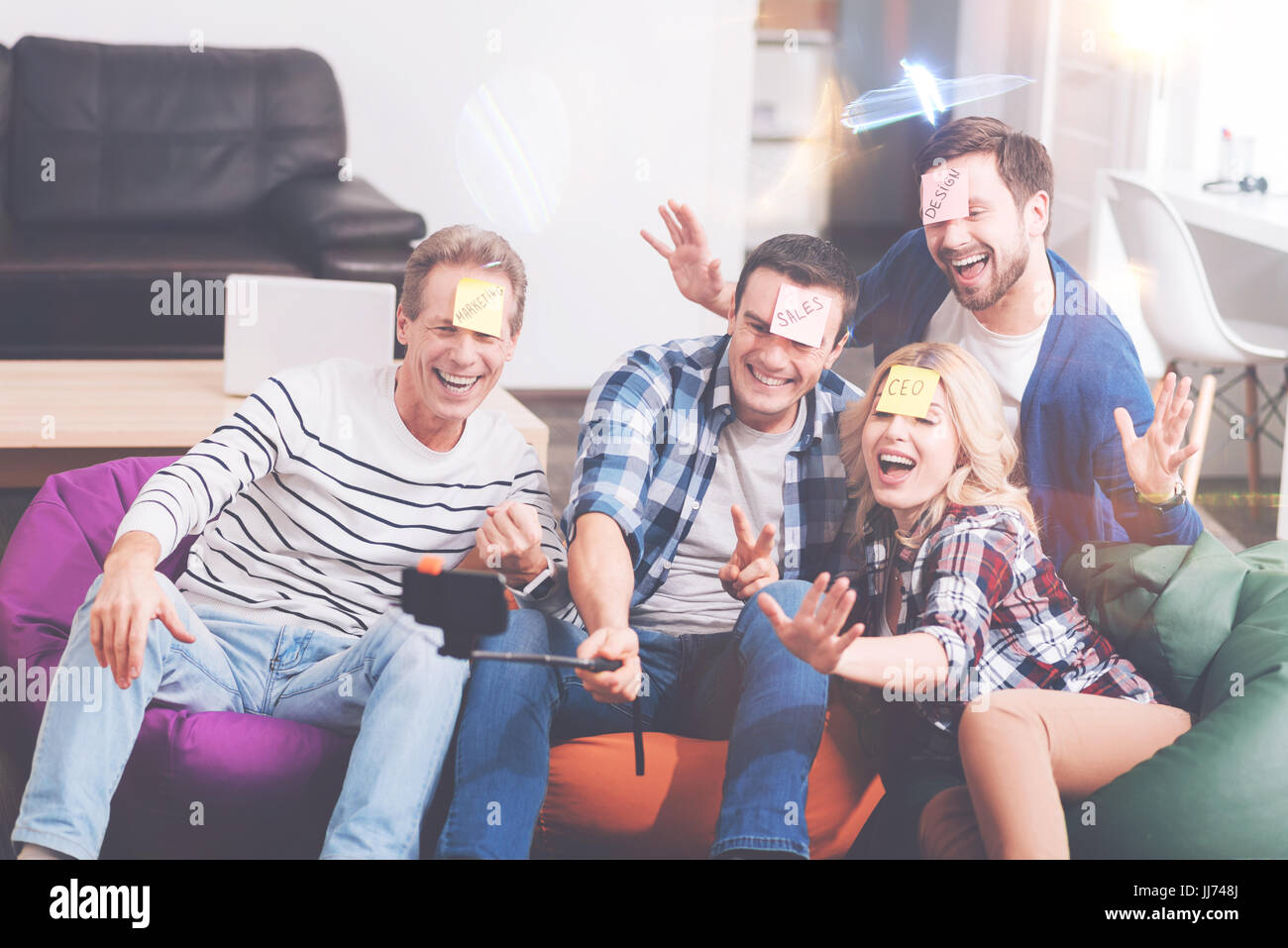 Overjoyed smilign colleagues makign selfies Stock Photo