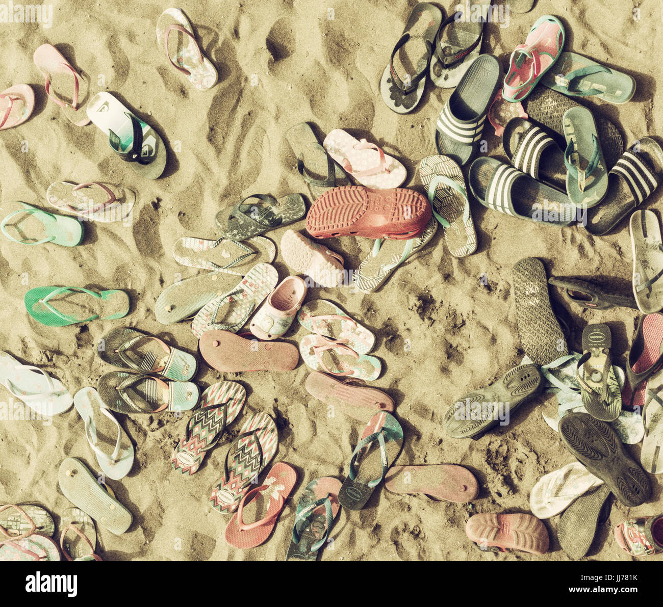 Swimmers flip flops on beach Stock Photo - Alamy