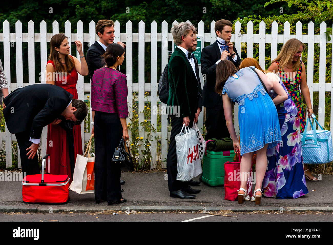 Young opera fans with their picnic baskets arrive at Lewes railway station en route to