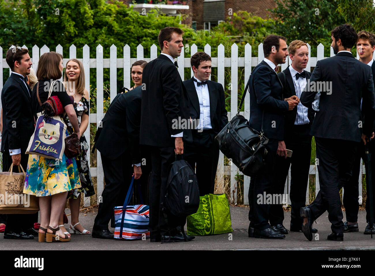 Young opera fans with their picnic baskets arrive at Lewes railway station en route to